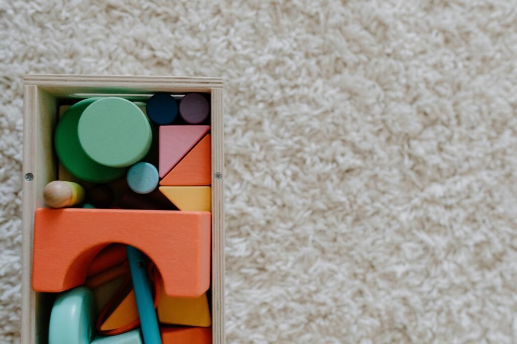 A set of colorful wooden blocks on a carpet, ideal for children's creative play.