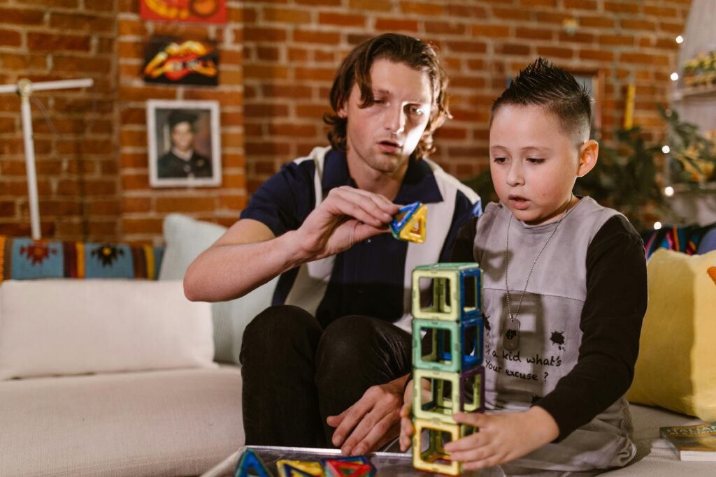 A father and son bonding over educational magnetic block play at home.