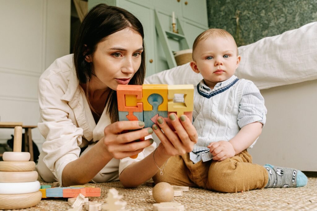 A mother and baby playing with colorful wooden blocks, capturing a moment of bonding and joy.