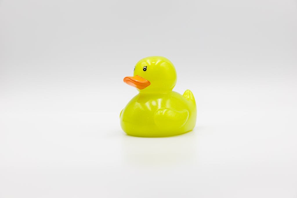 A vibrant yellow rubber duck placed against a plain white background.