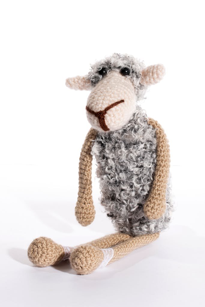 Adorable handmade crochet sheep toy with soft textures, perfect for children's decor or gifts.