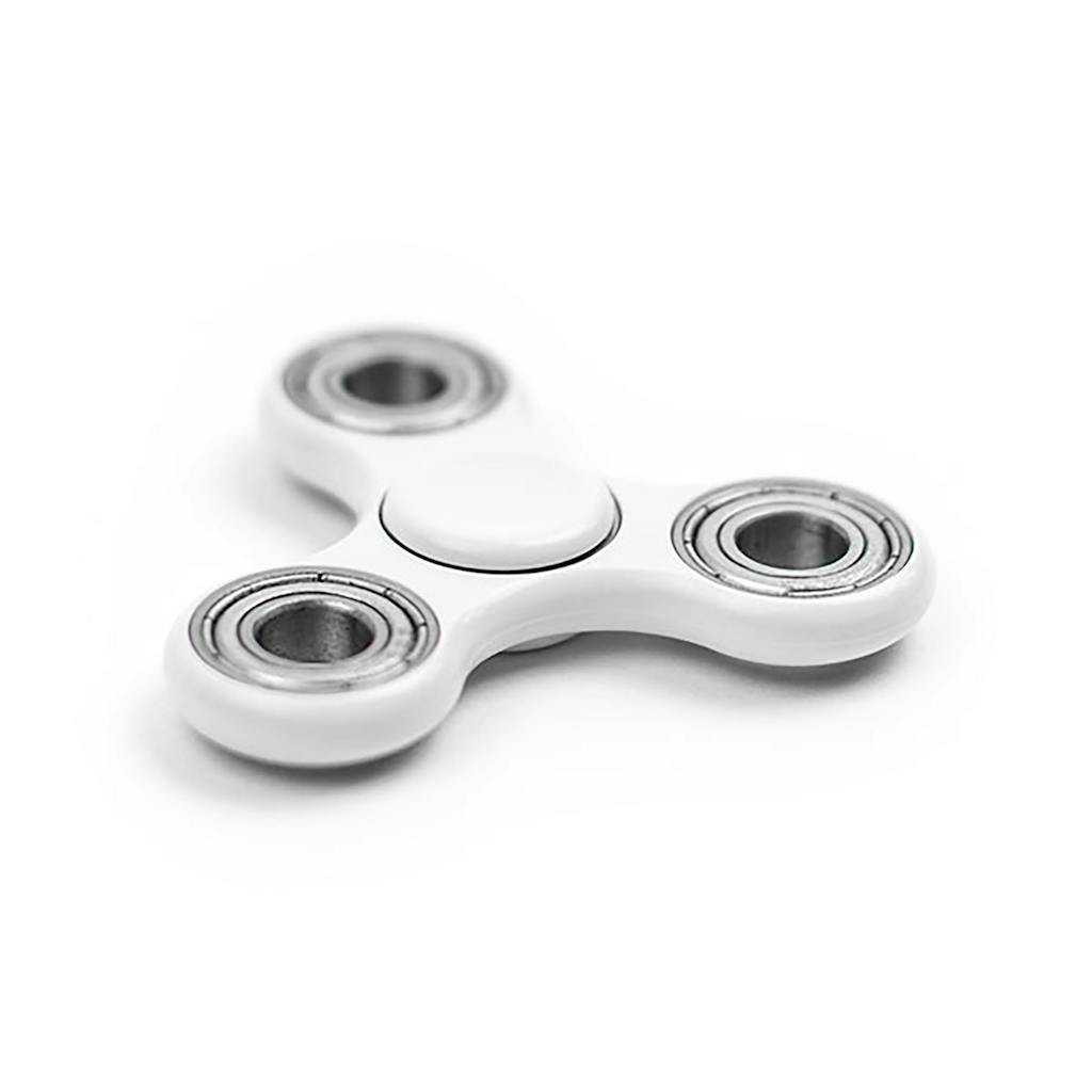 Close-up of a white fidget spinner showcasing its metallic bearings.